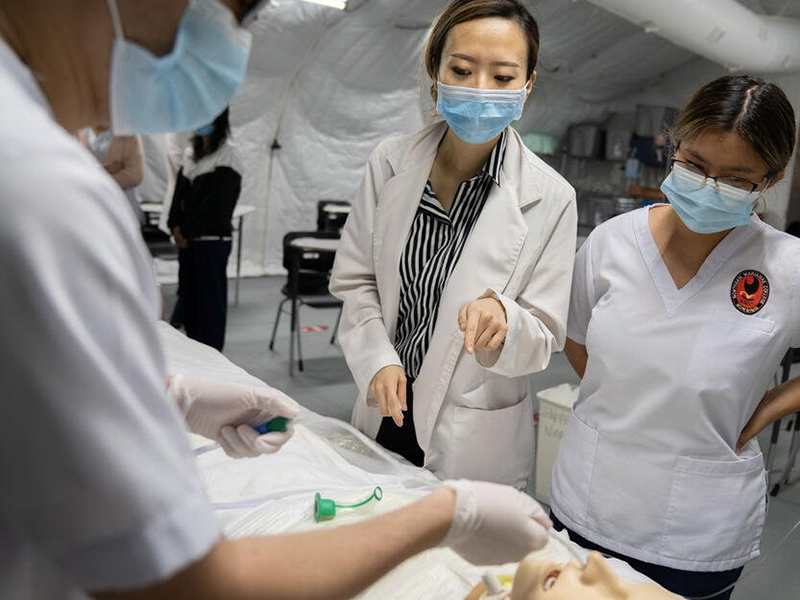 Northern Marianas College nursing instructor Min Jung "Mindy" Song explains a medical procedure to her students during a skills lab. 